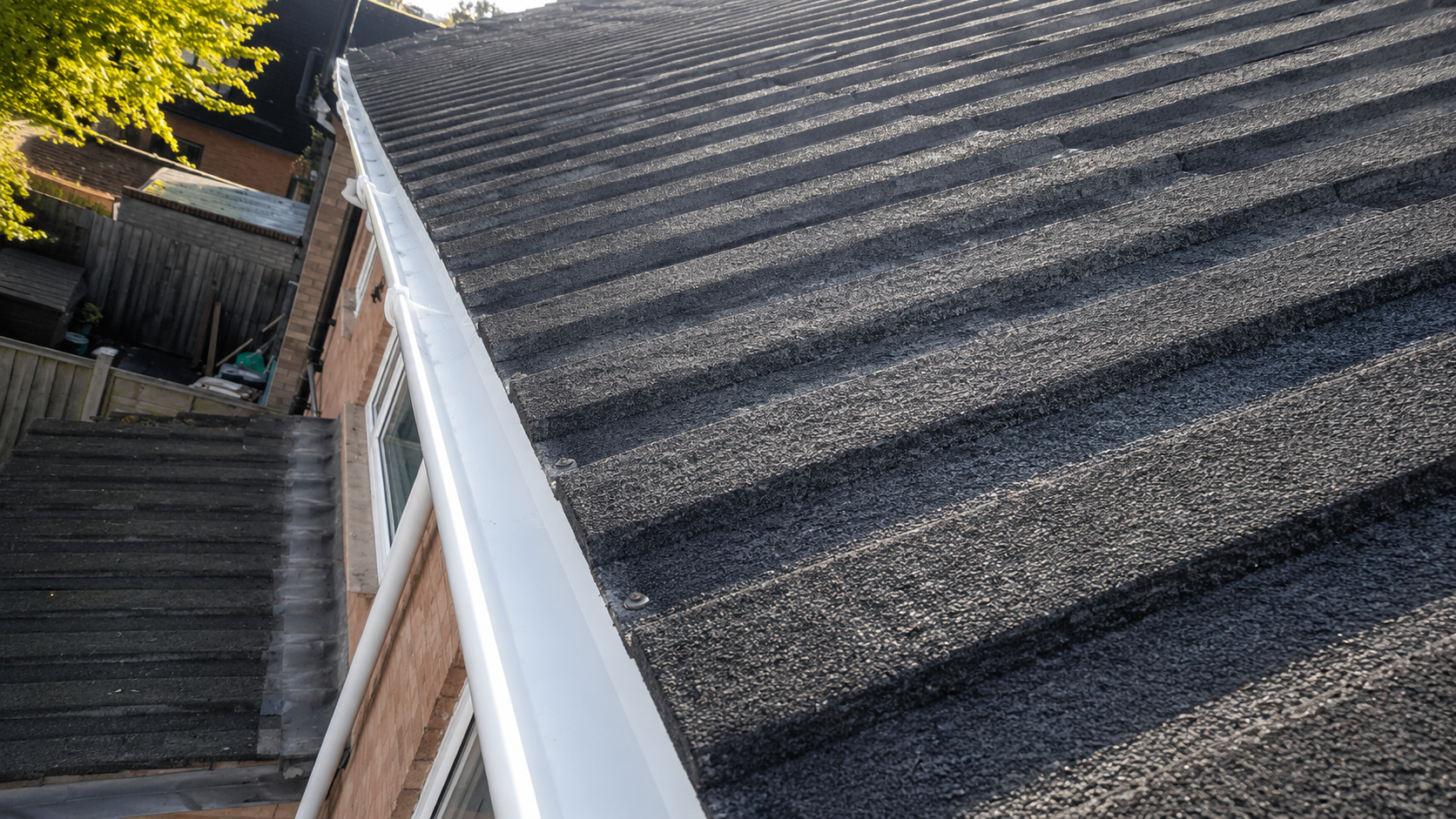 Flat roof drainage outlet after maintenance, showing clear outlet and unobstructed water flow