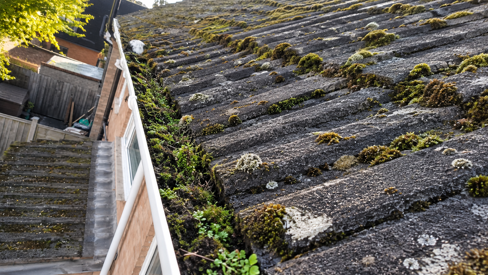 Flat roof drainage outlet and box gutter before maintenance, showing accumulated debris and restricted drainage